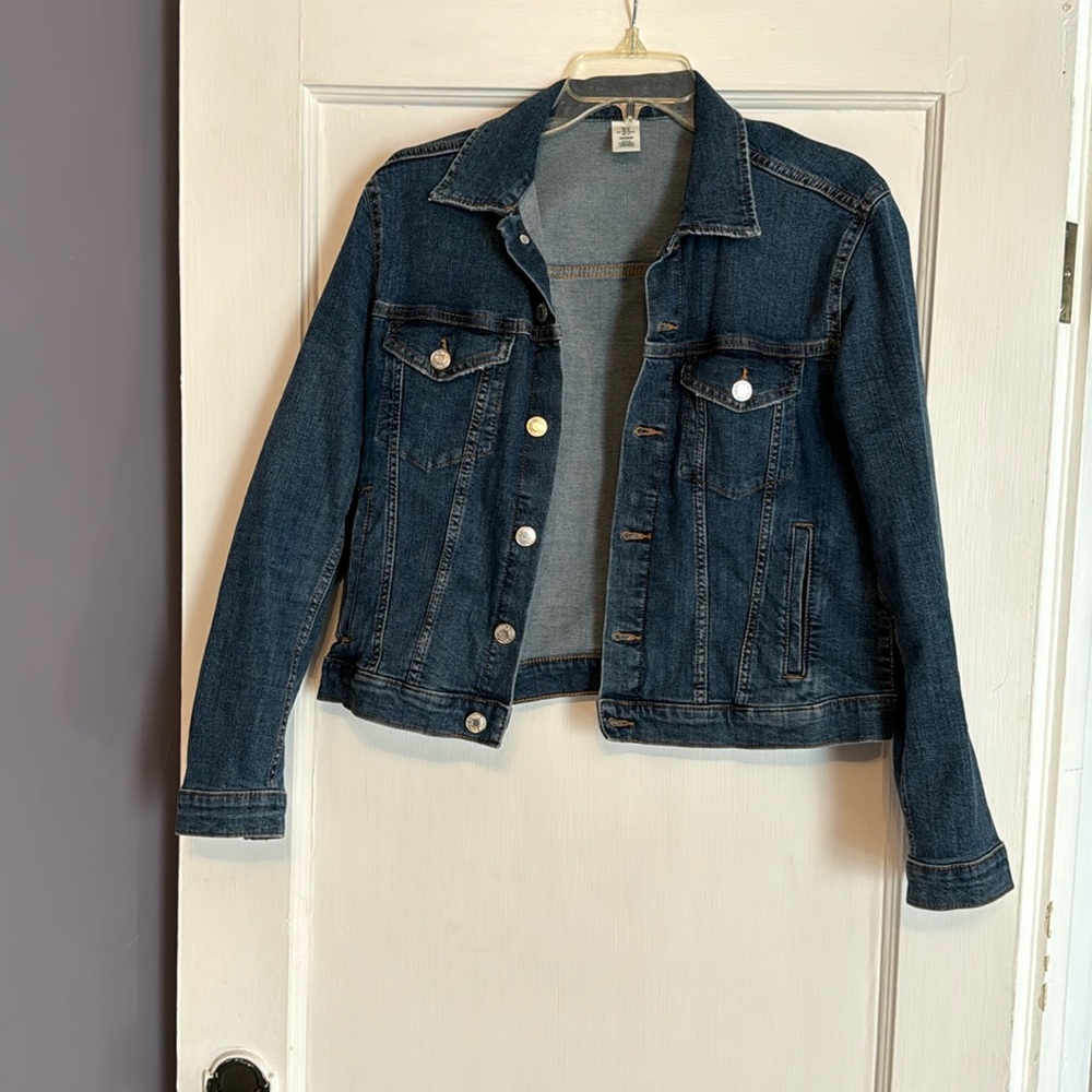 Denim jacket hits above waist.